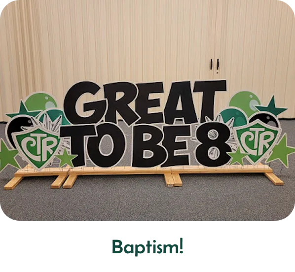 An image of a yard sign that says "Great to be 8" with other graphics around it. Text below the image says "Baptisms!"