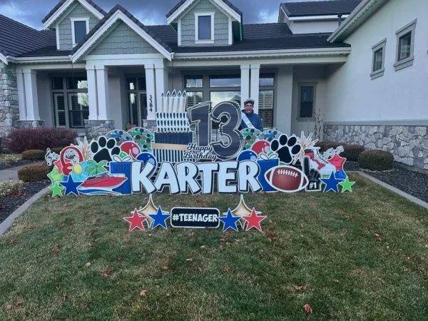 An image of a yard sign with a big number 13, the phrase "Happy Birthday Karter" and other graphics around it.